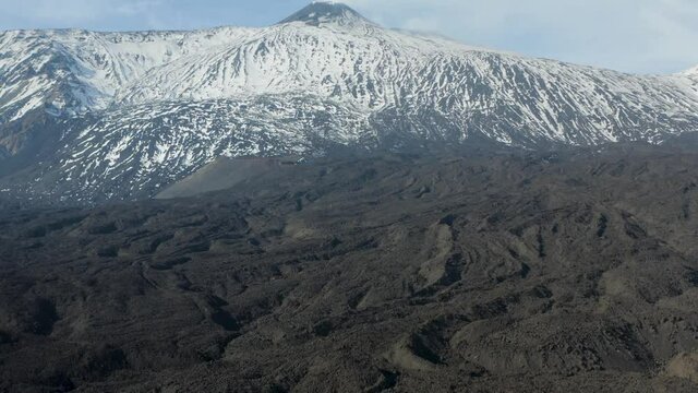 Etna with a view of the South East crater after a snowfall and the spectacular Valle del Bove with its dikes and solidified lava flows. Sicily. Italy.