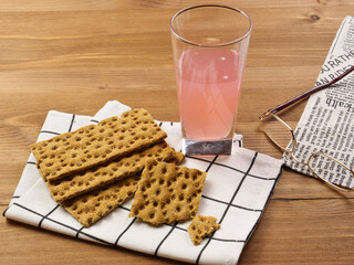 bread rolls ,  Juice  and newspaper 