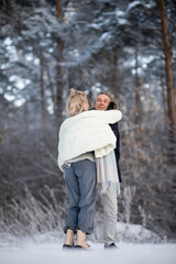 Fototapeta na wymiar adult man and woman hugging on the street in winter