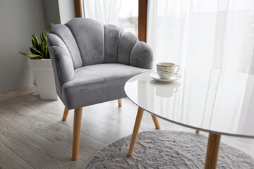 Modern Interior With Grey Armchair And White Coffee Table 