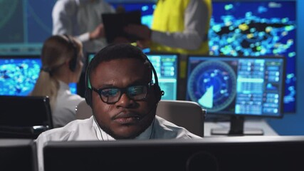 Workplace of the air traffic controllers in the control tower. Diverse team of aircraft control officers works using radar, computer navigation and digital maps. Aviation concept.