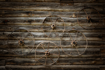 Fototapeta na wymiar Old metal wheels on a wall