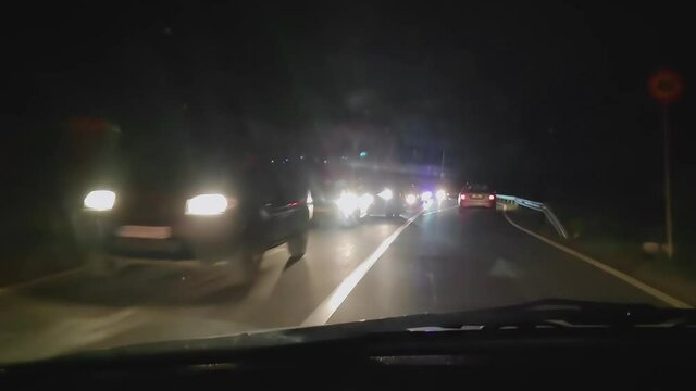 Traffic jam on the road at night. Lots of cars at night on the street. Traffic blockade due to accident