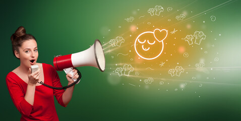 Young person shouting in megaphone and loved emoticon icon, healthy eating concept