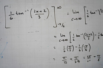 Maths equations on a classroom whiteboard  