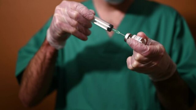 Medical doctor or laborant holding tube with nCoV Coronavirus vaccine for 2019-nCoV COVID virus. Coronavirus 2019-nCoV COVID concept.