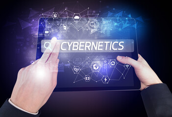 Close-up of a tablet searching CYBERNETICS inscription, hi-tech computing concept