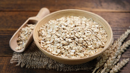 Rolled oats in a wooden bowl. Healthy whole grain oats