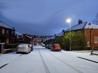 Obraz premium Evening Winter Street cover with white snow in amazing Town.