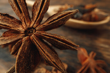 Macro photo of anise stars on wooden background