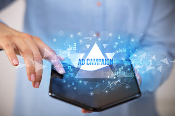 Businessman holding a foldable smartphone with AD CAMPAIGN inscription, business concept