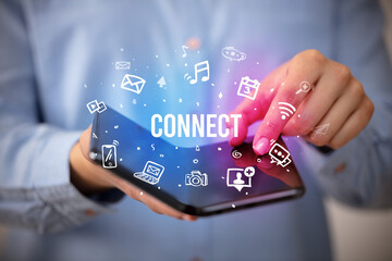 Businessman holding a foldable smartphone with CONNECT inscription, social media concept