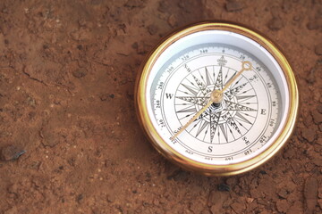 Fototapeta na wymiar round compass on rusty background as symbol of tourism with compass, travel with compass and outdoor activities with compass