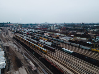 Fototapeta na wymiar aerial view of large railroad tracks with a lot of trains in an urban environment