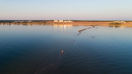 Aerial view of beautiful beach at sunset. People are walking on long sandbanks at Kalajoki. Famous beach in Finland