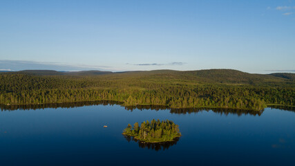 Picturesque Aerial View of  Scenic Island surrounded by Peaceful Lake Inari. Lapland.
