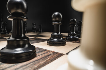 Chess board with figures on dark background