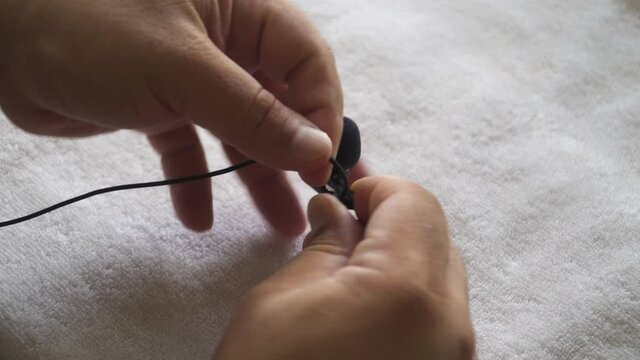 A man loops a lapel mic