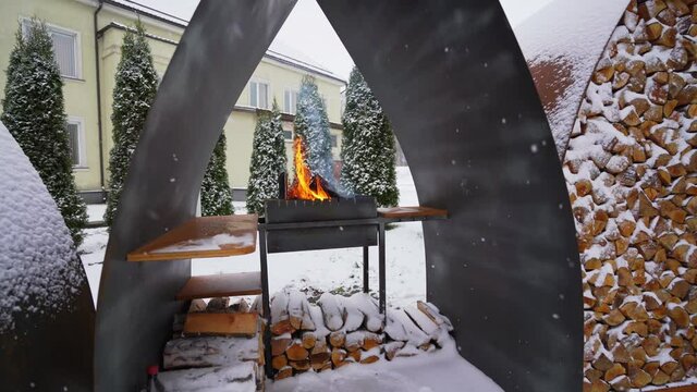Roasting grill meat outdoors. Burning fire in winter. Closeup slow motion footage.