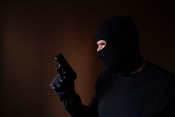 Series of a Caucasian burglar breaking into a house with gun in hand.
