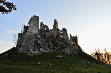 Majestic view of gothic castle Hrusov, central Slovakia, from northern side, sunbathing in evening winter sunshine. 