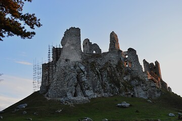 Majestic view of gothic castle Hrusov from northern side in winter afternoon sunshine. Photo taken during restoration in year 2020, scaffolding visible on eastern walls. 