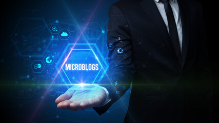 Man hand holding MICROBLOGS inscription, social media concept