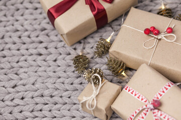 Christmas gift boxes on knitted background. New Year presents.