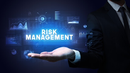 Hand of Businessman holding RISK MANAGEMENT inscription, business success concept
