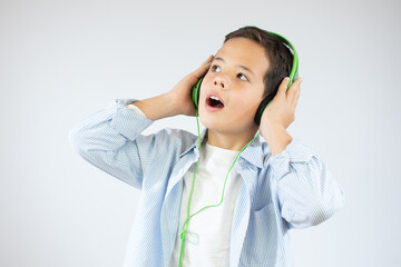 Fototapeta premium Happy teen beautiful boy with headphones, isolated on white background