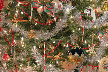 Close-up of lights, tinsel, and decorations on a Christmas tree.