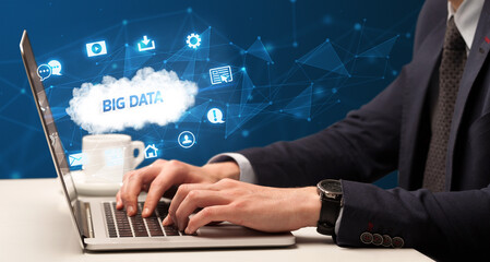 Businessman working on laptop with BIG DATA inscription, modern technology concept