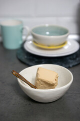 A portion of ice cream in a bowl on the table in the kitchen
