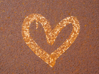 Heart painted on rusty surface. Corrosion of metal texture closeup. Heavily corroded metal sheet. Abstract art. Symbol of love, romantic concept.