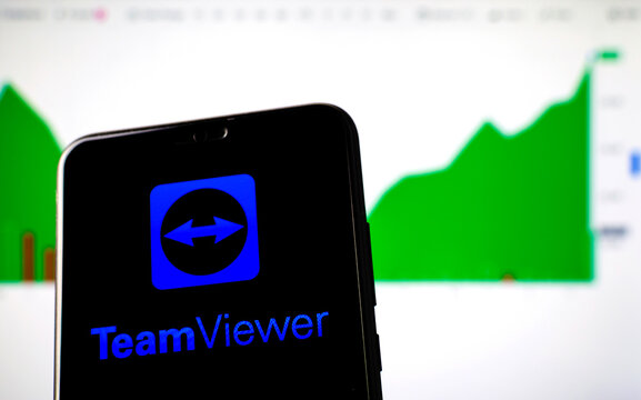 Stone, Staffordshire / United Kingdom - November 11 2019: TeamViewer logo on the smartphone screen and the actual TeamViewer stock price graph on the background, showing the growth.