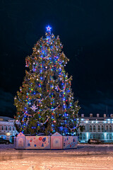 Christmas tree with baubles and garlands in the city square.