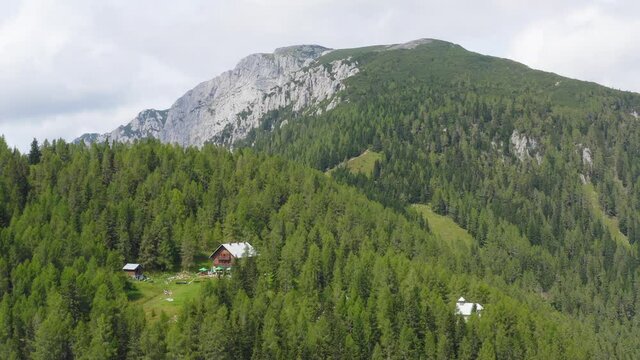 Aerial drone scenic view of mountains with mountain hut in foreground