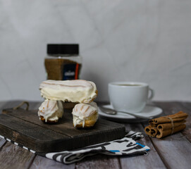 Custard cakes on a dark Board with black coffee Grand