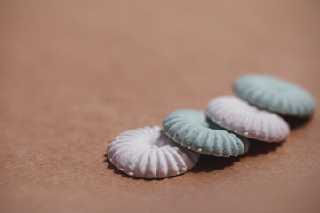 Small marshmallows made of polymer clay close-up on craft paper. Miniatures of sweets for dolls and games.