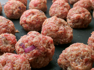 Close up of raw Swedish meatballs prepared for frying