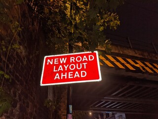 UK road sign reading 'new road layout ahead.'
