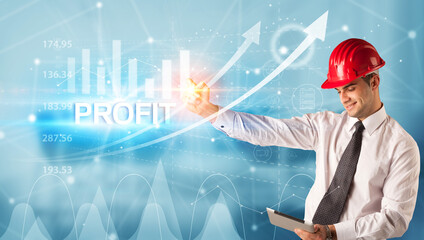 Young businessman with helmet drawing PROFIT inscription, modern business technology concept