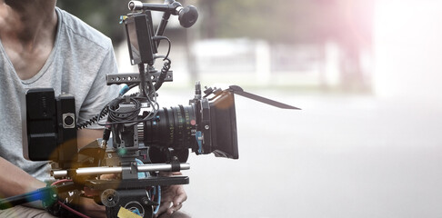 Film industry. Filming with professional camera. Videographer holding 4k cam on dslr rig or gimbal stabilizer set. Pro equipment helps to make videos without shaking. video production.