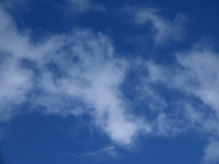 Naklejka na ściany i meble Beautiful white cloud against a blue sky in winter in Israel. Close-up nature.