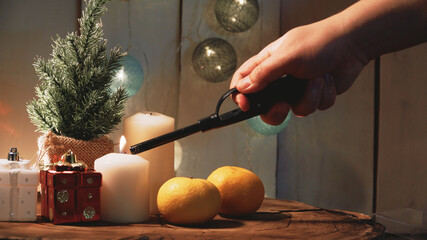 Small Christmas tree and candles on a wooden background