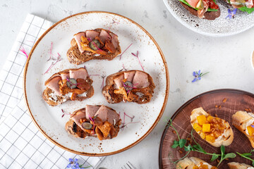 Smorrebrod, a traditional Scandinavian appetizer, open sandwich with chanterelle mushrooms and ham...