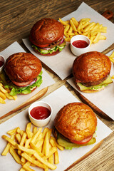 Set of burgers with french fries and ketchup sauce.