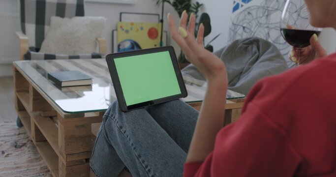 woman holding tablet computer with green screen
