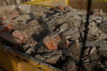 Bricks and rubbish after demolition with rotten and rusty metals.