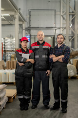 Fototapeta premium Group of successful male and female professionals standing in aisle in warehouse